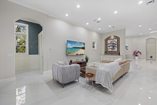 living room with visible vents, arched walkways, baseboards, ornamental molding, and marble finish floor