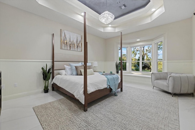 bedroom featuring recessed lighting, a wainscoted wall, a notable chandelier, visible vents, and a tray ceiling