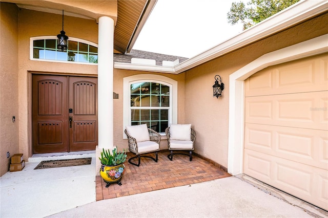 doorway to property with a porch and a garage