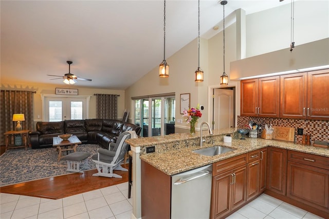 kitchen with kitchen peninsula, french doors, a wealth of natural light, and dishwasher