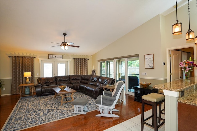 living room with french doors, light hardwood / wood-style flooring, ceiling fan, and a healthy amount of sunlight