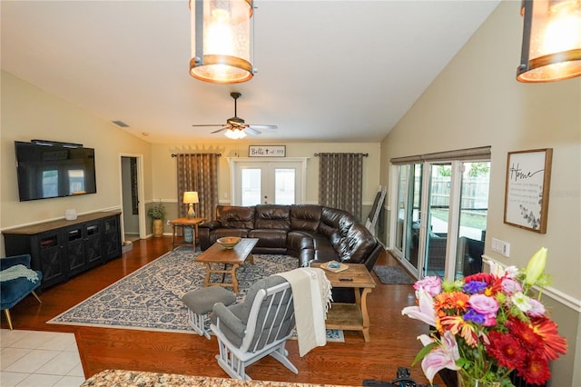 living room with ceiling fan, light wood-type flooring, lofted ceiling, and french doors