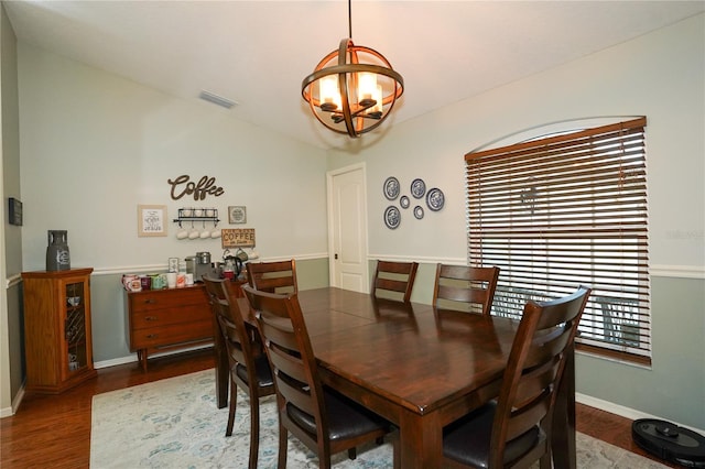 dining room featuring dark hardwood / wood-style floors and a notable chandelier