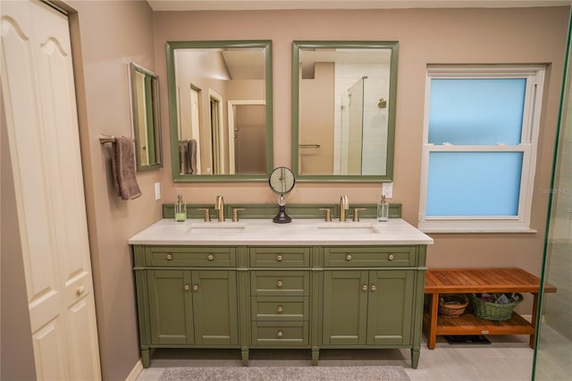 bathroom with vanity and a shower with door