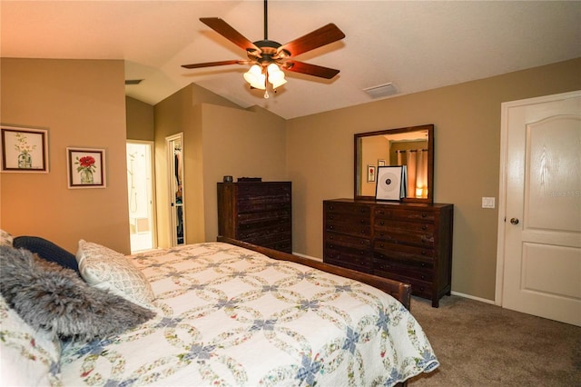 carpeted bedroom with ceiling fan and vaulted ceiling