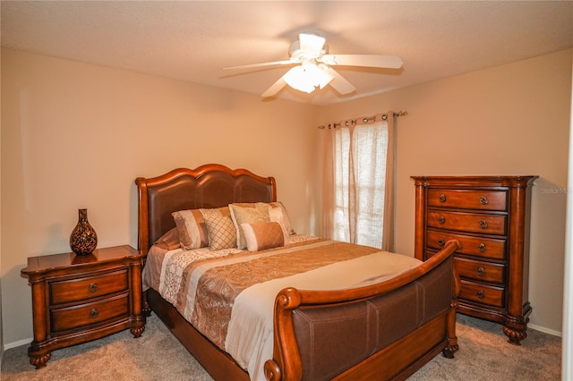 bedroom featuring light colored carpet and ceiling fan