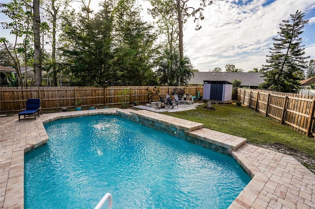 view of swimming pool featuring a storage unit and a patio