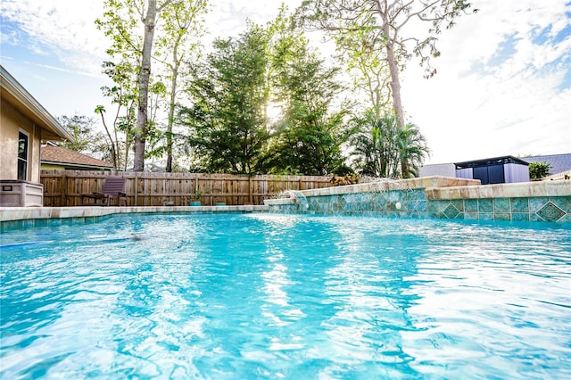 view of swimming pool with pool water feature