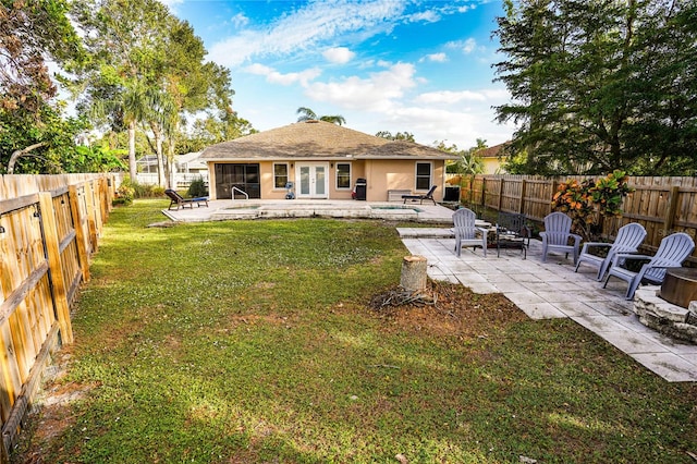 back of property featuring french doors, a patio, and a lawn