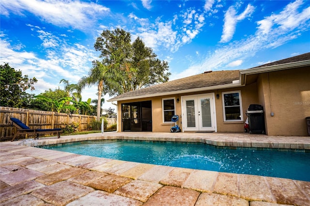 view of swimming pool featuring a grill, french doors, and a patio