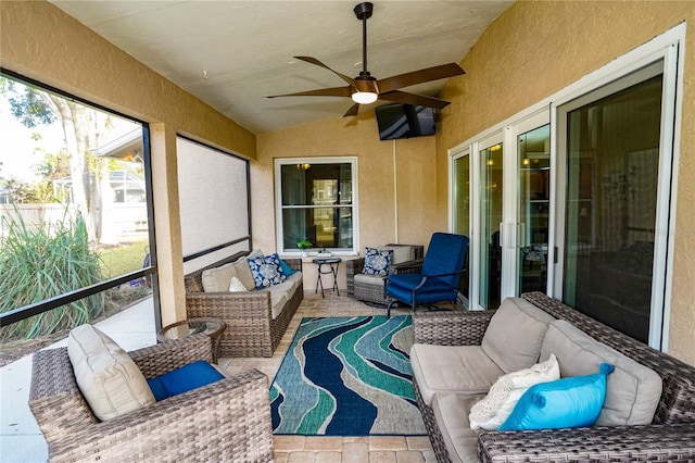 sunroom / solarium featuring ceiling fan and lofted ceiling