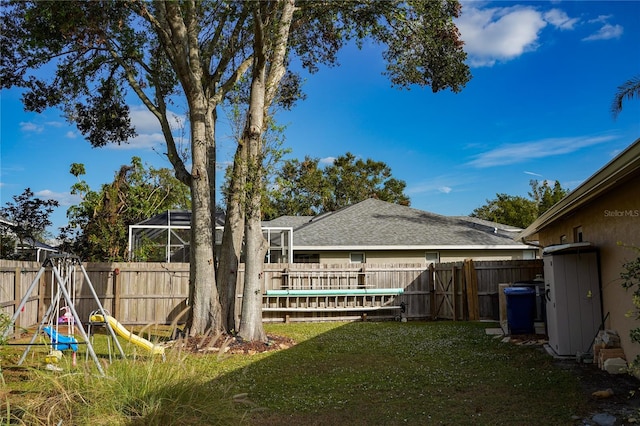 view of yard with glass enclosure