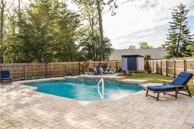 view of swimming pool featuring pool water feature, a storage unit, and a patio area