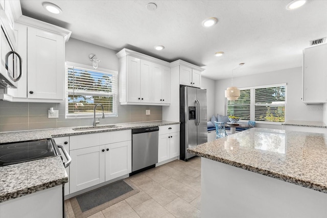 kitchen featuring white cabinets, plenty of natural light, sink, and appliances with stainless steel finishes