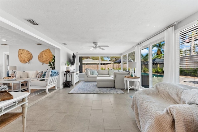 sunroom / solarium featuring plenty of natural light and ceiling fan