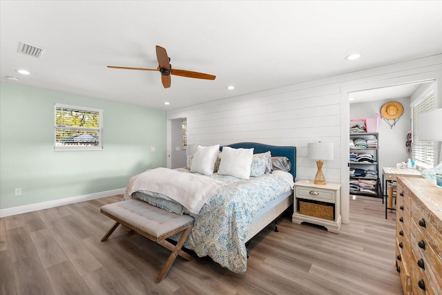 bedroom with ceiling fan and light hardwood / wood-style floors