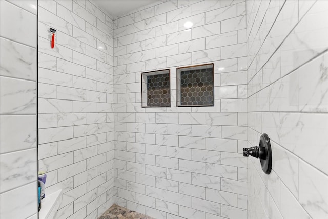 bathroom with tiled shower