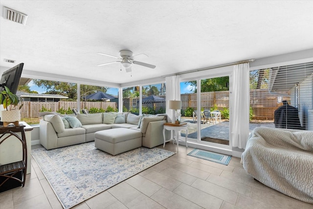 sunroom / solarium featuring plenty of natural light and ceiling fan