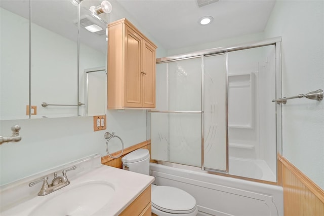 full bathroom with vanity, toilet, and shower / bath combination with glass door