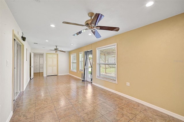 tiled empty room featuring ceiling fan