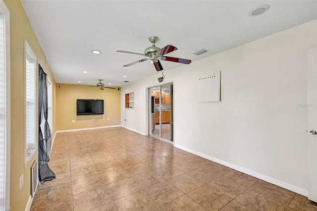 unfurnished living room with ceiling fan