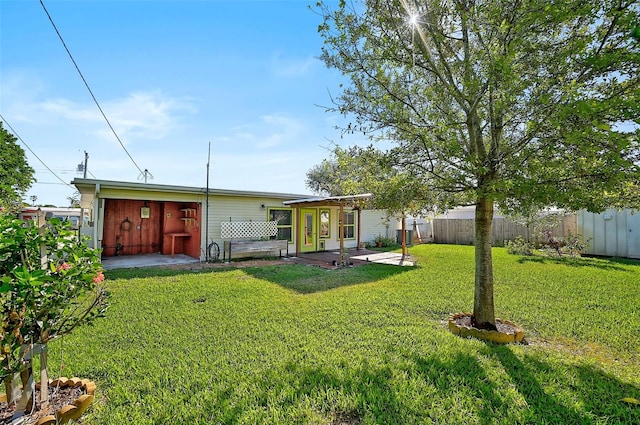 back of property featuring a lawn