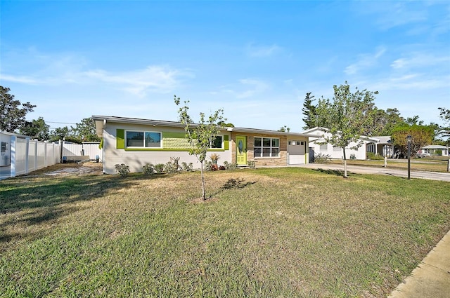 ranch-style home with a garage and a front lawn