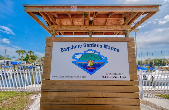 community sign featuring a water view