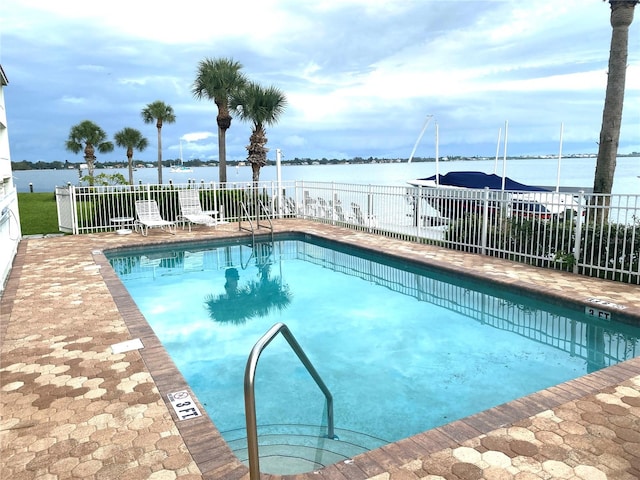 view of pool with a water view