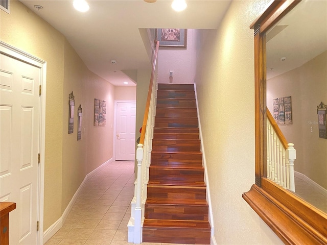 stairs with tile patterned floors