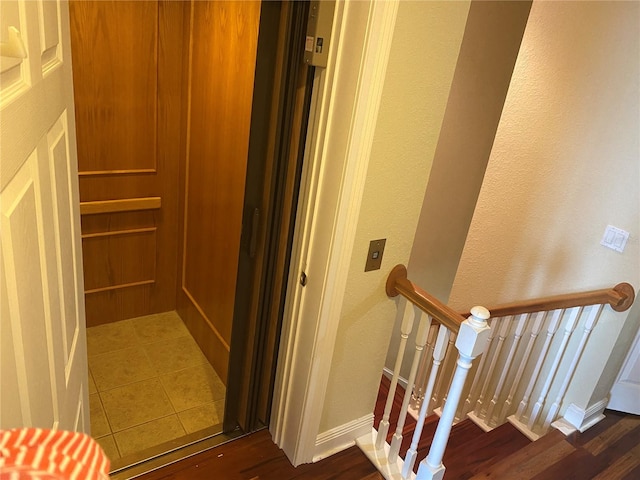 interior space with hardwood / wood-style floors and elevator