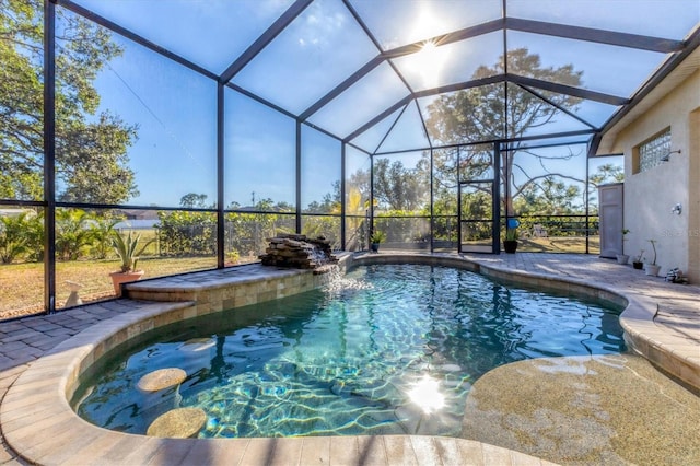 view of swimming pool with a lanai and a patio area