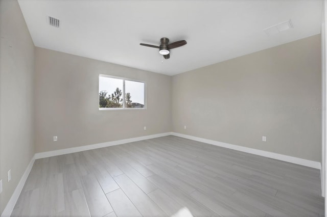 spare room with ceiling fan and light hardwood / wood-style floors