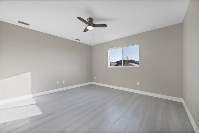 empty room with ceiling fan and light wood-type flooring