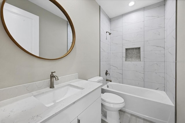 full bathroom with vanity, toilet, and tiled shower / bath