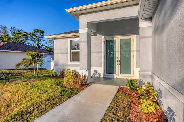 view of exterior entry with a yard