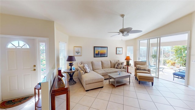 tiled living room featuring ceiling fan and vaulted ceiling