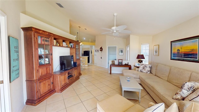 tiled living room featuring ceiling fan and vaulted ceiling