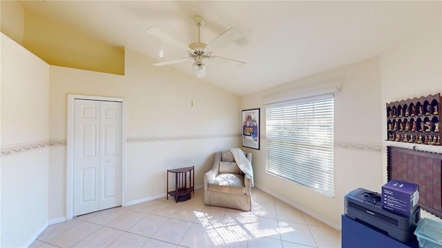 sitting room with ceiling fan, light tile patterned floors, and lofted ceiling