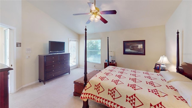 bedroom with ceiling fan, light colored carpet, and vaulted ceiling