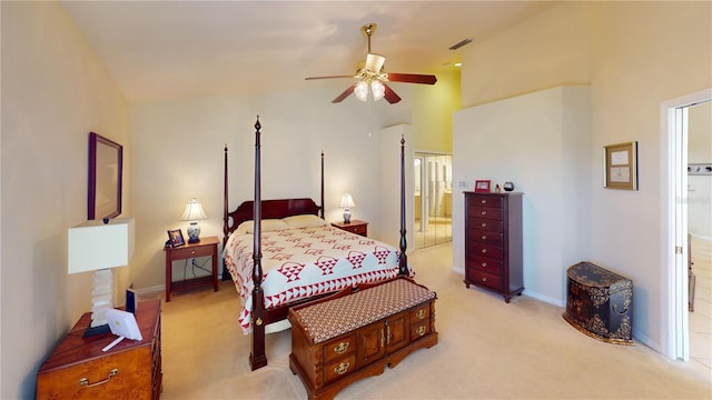 bedroom with ceiling fan, ensuite bathroom, and light carpet