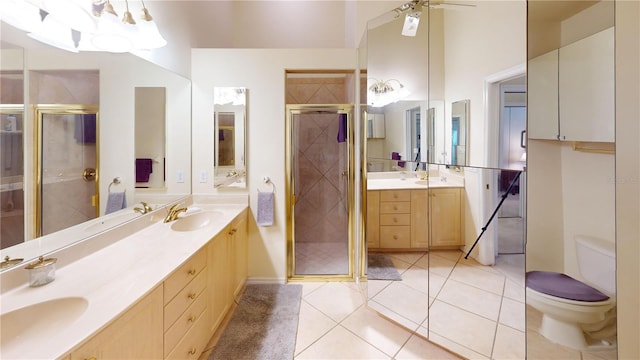 bathroom with ceiling fan, walk in shower, tile patterned floors, toilet, and vanity