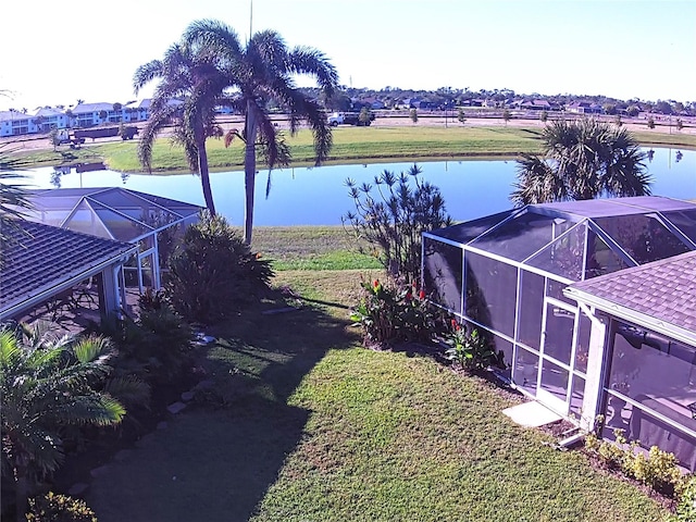 view of yard featuring a water view and a lanai