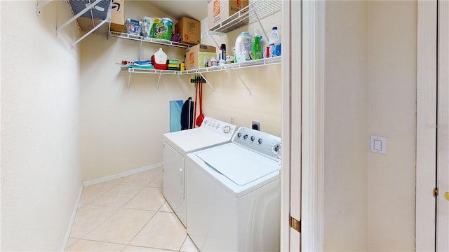 laundry room with light tile patterned floors and separate washer and dryer