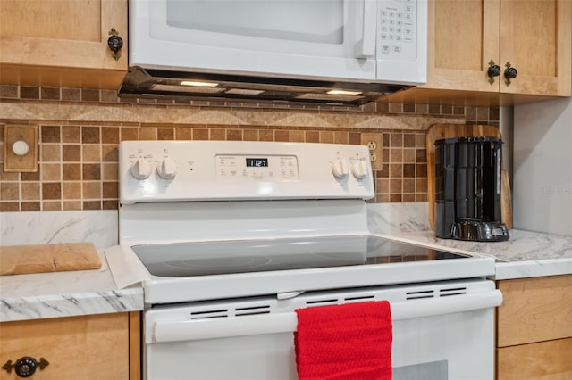 kitchen with decorative backsplash and white appliances