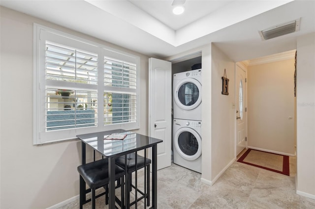 laundry area featuring stacked washer and dryer