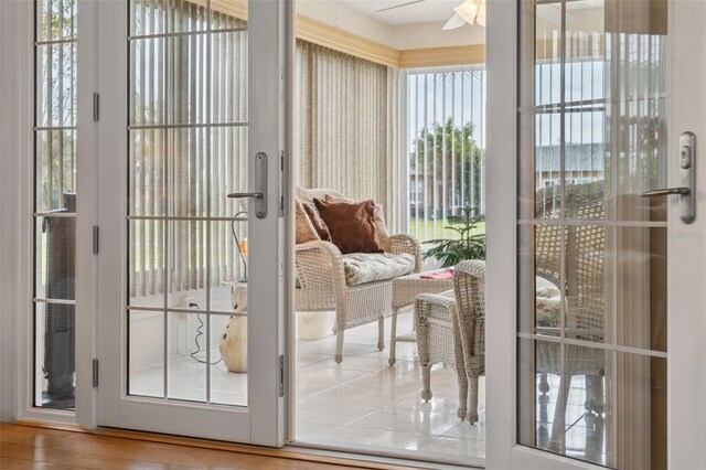 doorway to outside with ceiling fan, plenty of natural light, and wood-type flooring