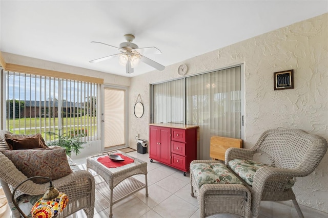 interior space with ceiling fan, light tile patterned flooring, and a healthy amount of sunlight