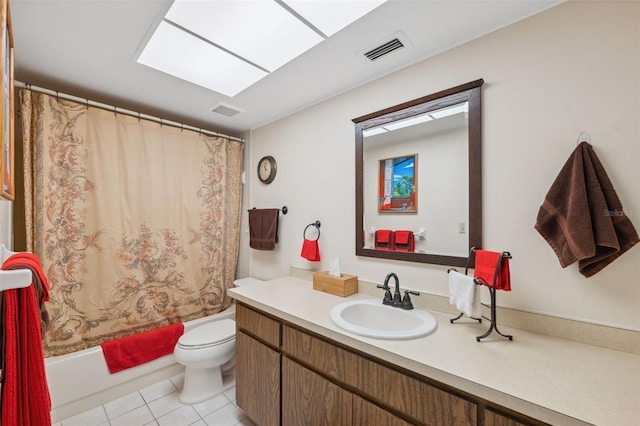 full bathroom featuring vanity, tile patterned floors, a skylight, toilet, and shower / bathtub combination with curtain