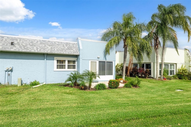 rear view of property featuring a yard